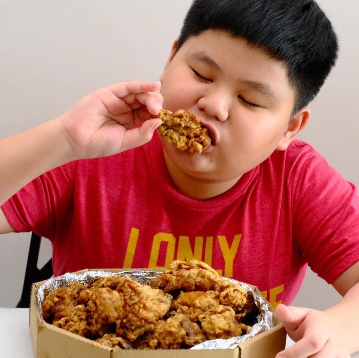 Happy customer enjoying BIG5 fried chicken